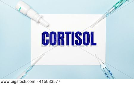 On A Light Blue Background, Syringes, A Medicine Bottle, An Ampoule And A White Sheet Of Paper With 