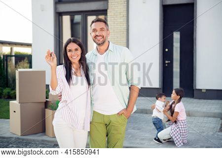 Photo Of Happy Smiling Family Moving To New House Mom And Dad Hug Each Other Hold Keys From New Home