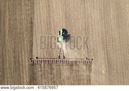The Tractor Cultivates The Soil View From The Drone