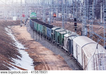 Long Freight Train Approaches To The Station.
