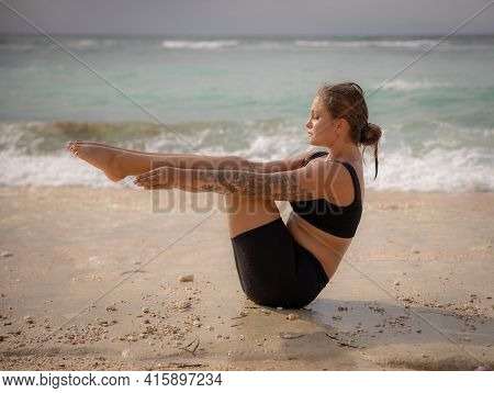 Yoga Outdoor. Attractive Woman Practicing Paripurna Navasana, Boat Pose. Balance And Concentration. 