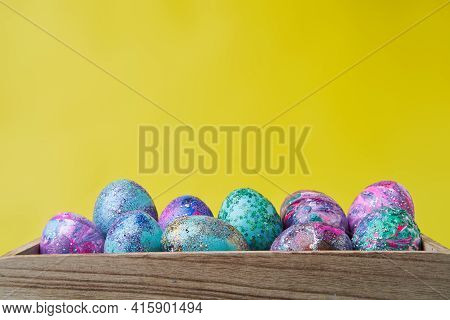 Colorful Painted Eggs With Bright Shiny Gliter In Wooden Box