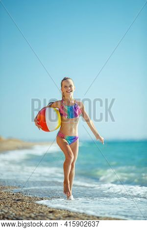 Child Girl Runs On The Waves. Rest By The Sea, Fun Outdoors. High Quality Photo.