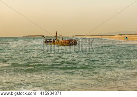 Sunset View Of A Rusty Shipwreck In Habonim Beach, Northern Israel