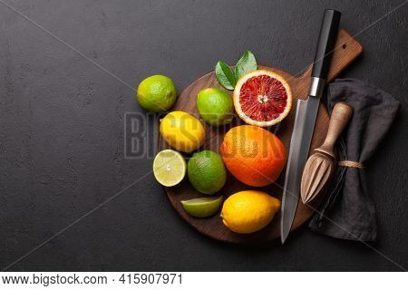 Various fresh citrus fruits. Bood orange, lime, lemon. Top view flat lay with copy space