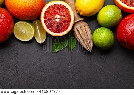 Various fresh citrus fruits. Bood orange, lime, lemon. Top view flat lay with copy space