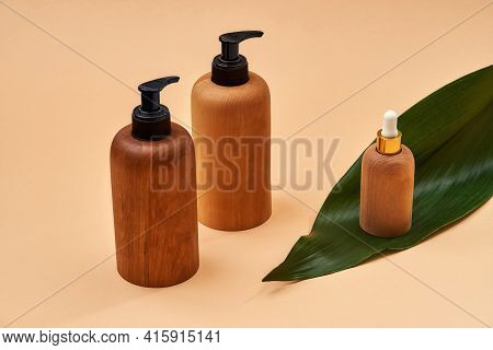 Wooden Bottles Or Containers Of Different Sizes Isolated On Beige Background. Zero Waste And Eco Con