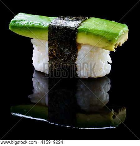 Sushi Nigiri With Avocado On Black Background With Reflection