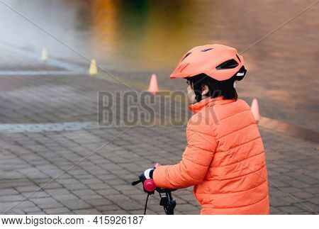 School Kid Learns To Ride A Bike In The Park, Outdoor Portrait Of A Young Boy On Bicycle,  Child In 
