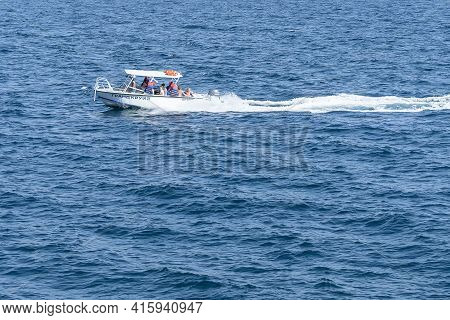 White Fast Boat Sails By Sea. Sunny Autumn Day. Side View. Crimea, Sudak - 10 October 2020.