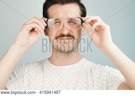 Young Man In Big Glasses Squints At The Camera, Close-up. Health Problem Concept, Low Vision, Glasse