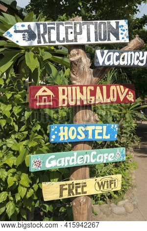 Gili Air Island, Indonesia, March 25: Various Rustic Hostal Signs On Wooden Signpost In Bali. Indone