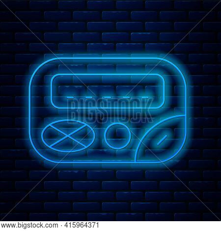 Glowing Neon Line Pager Icon Isolated On Brick Wall Background. Vintage 1990s Electronics Messenger.