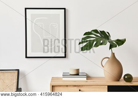 Stylish Interior Of Living Room With Mock Up Poster Frame, Wooden Commode, Book, Tropical Leaf In Ce