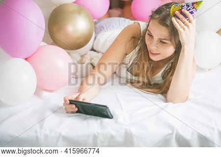 Lovely Lady In Pajama Making Selfie In Her Bedroom Using Phone. Happy Birthday. Girl Is  Lying On Be