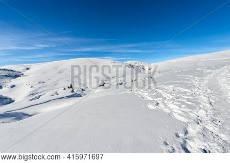 Lessinia High Plateau (altopiano Della Lessinia) And Peak Of Monte Tomba (tomb Mountain) In Winter W