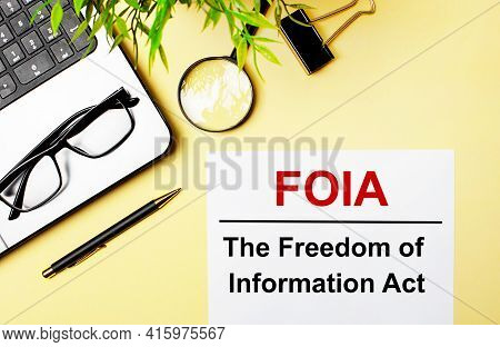 Foia The Freedom Of Information Act Is Written In Red On A White Piece Of Paper On A Light Yellow Ba