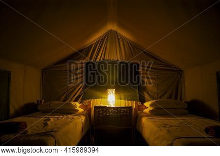 Interior Of Tent With Two Beds Set Up At Night During A Safari In Maun, Botswana.