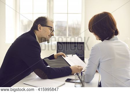 Male Business Consultant And Client Meeting Or Two Colleagues Briefing In Office