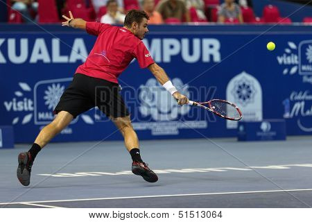 KUALA LUMPUR - SEPTEMBER 27: Stan Wawrinka plays a return to Dimitry Tursunov during a quarter-final match at the Malaysia Open 2013 tennis played at the Putra Stadium, Malaysia on September 27, 2013.