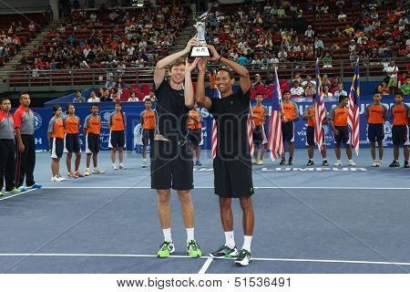 KUALA LUMPUR - SEPTEMBER 29: Eric Butorac (left) and Raaven Klassen lift the doubles champion's trophy of the Malaysian Open 2013 in Stadium Putra, Kuala Lumpur, Malaysia on September 29, 2013.