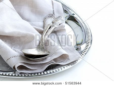 vintage cutlery with old-fashioned napkin on a silver tray