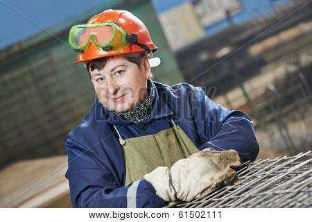adult industrial female worker spot welder in factory workshop