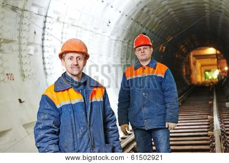 Two tunnel workers mounters at underground subway metro construction site