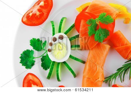 smoked salmon slices with vegetabls over white plate