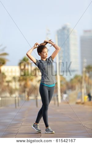 Runner woman running on Barcelona Beach, Barceloneta. Healthy lifestyle girl runner training outside on boardwalk. Mixed race Asian Caucasian fitness woman working out outdoors in Catalonia, Spain.