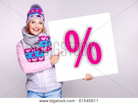Woman In Warm Outerwear  Holds The Banner With Per?ent Symbol