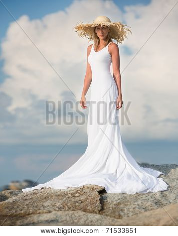 Beautiful and slim woman stand in white long dress
