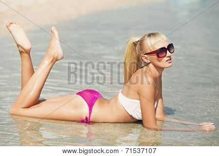 Sexy bikini girl posing at beach
