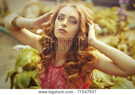 Beautiful young woman with makeup in fashion clothes on nature