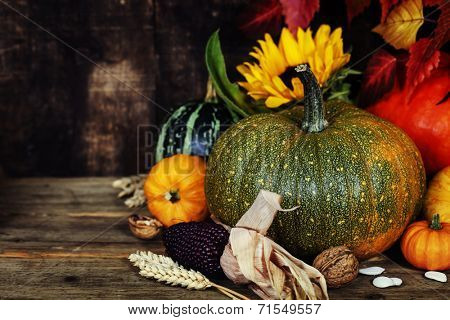 Autumn composition ( pumpkins and corn on old wooden table). Thanksgiving day concept