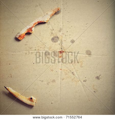 Remnants of pizza in a box
