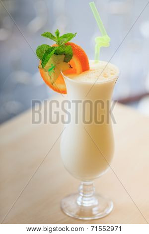 Milk cocktail with orange and carom
