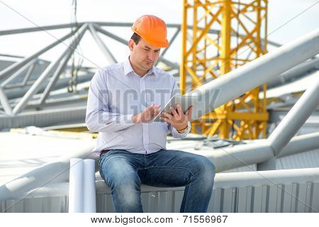 A Foreman With Digital Tablet At The Construction Supervising The Project.