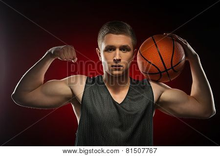 Caucasian basketball athlete demonstrating his biceps