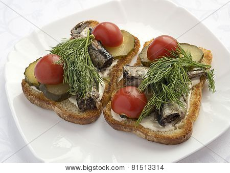 Sandwiches with sprats ,cucumbers and tomatoes