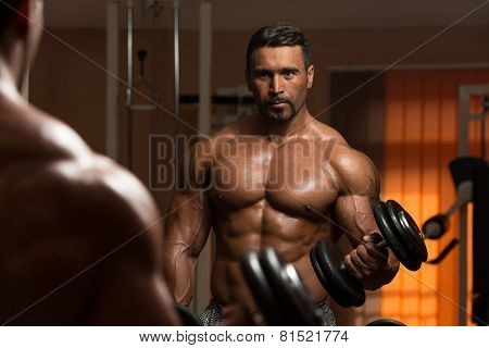 Bodybuilder Doing Exercise For Biceps