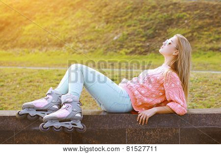 Fashion, Extreme, Fun, Youth And People Concept - Pretty Stylish Blonde With Roller Skates In The Ci