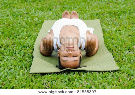 Beautiful Woman Practicing Yoga In The Park