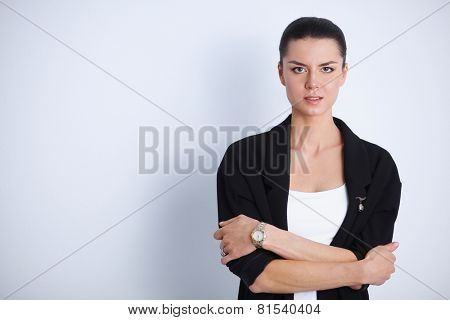 A young woman standing, isolated on graybackground