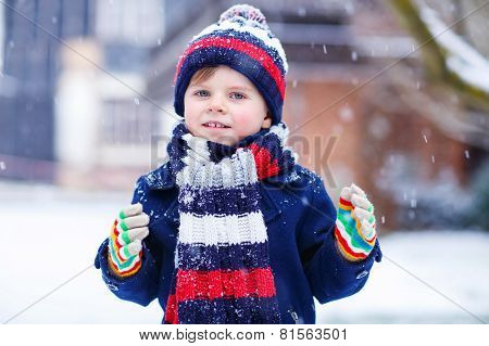 Cute Little Funny Boy In Colorful Winter Clothes Having Fun With