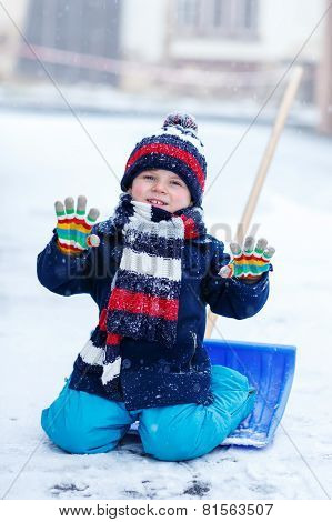 Cute Little Funny Boy In Colorful Winter Clothes Having Fun With