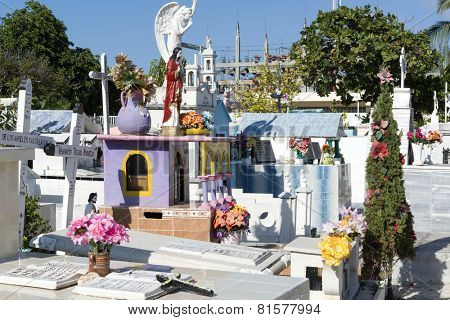 ISLA MUJERES - JANUARY 21: Local colorful cemetery in the town on 21 January 2015 in Isla Mujeres, Mexico. The cemetery is full of traditional colorful tombstones.