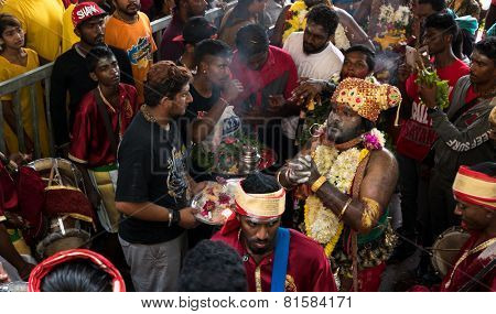 KUALA LUMPUR, MALAYSIA - JANUARY 31, 2015: Hindu devotees perform prayers at the Sri Mahamarriamman temple inside Batu Caves. Hundreds of thousands of devotees come here for the Thaipusam prayers.