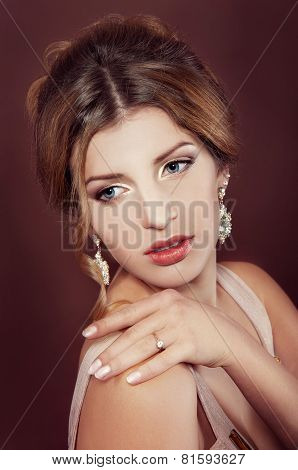 Studio Portrait Of A Beautiful Dark Blond Woman With Evening Hairdo And Makeup