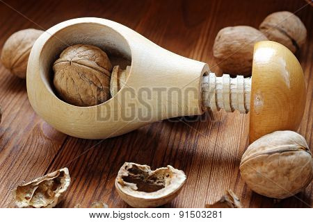 Wooden Nutcracker And Walnuts On A Wooden Table